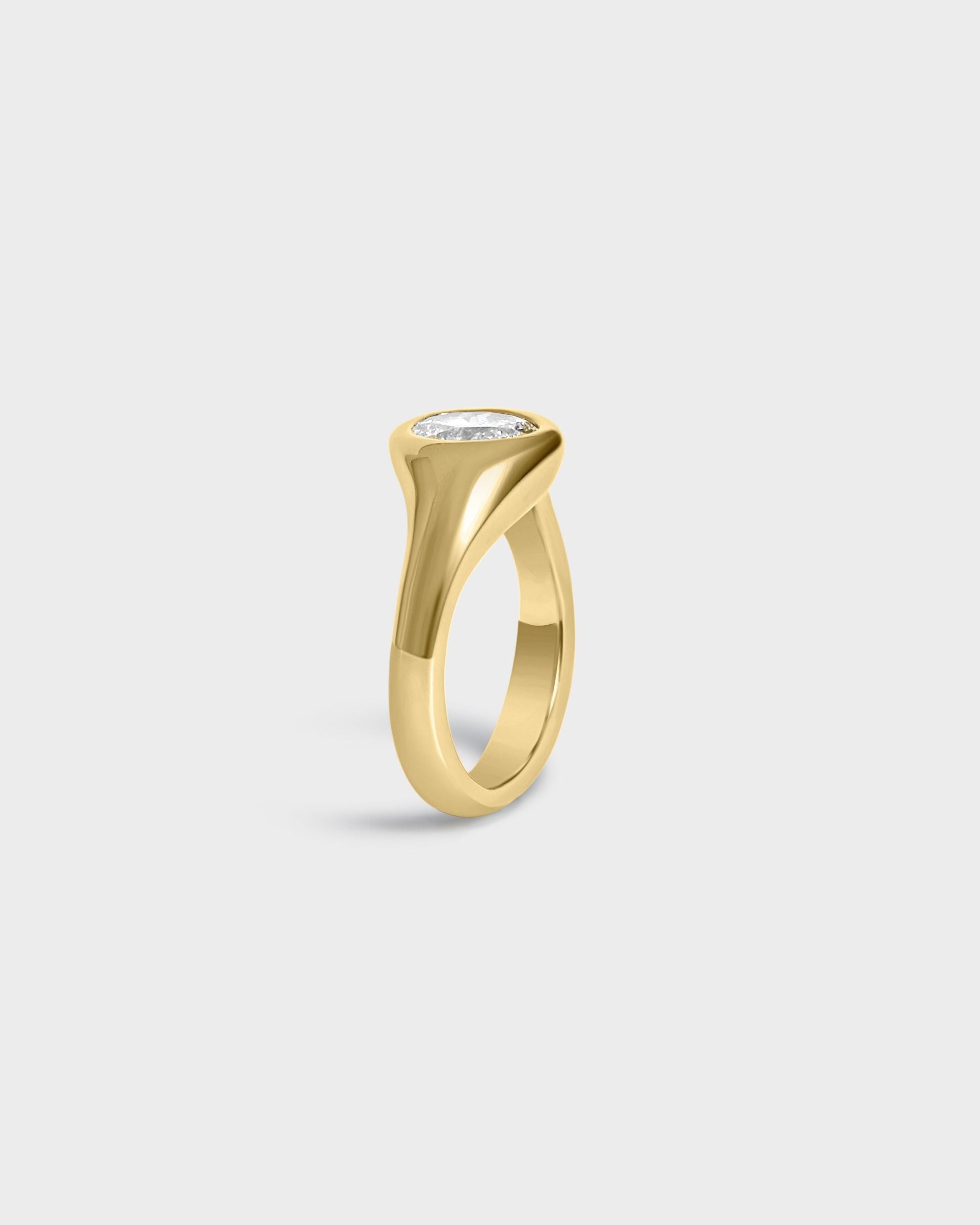 Asymmetrical oval diamond gold engagement ring